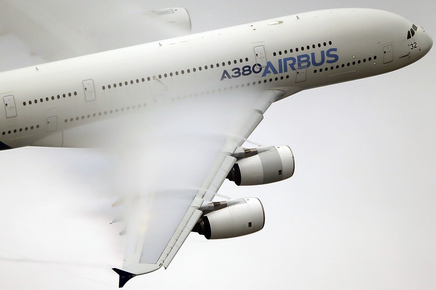 FILE - In this June 18 2015 file photo, vapor forms across the wings of an Airbus A380 as it performs a demonstration flight at the Paris Air Show, Le Bourget airport, north of Paris. Emirates airline ...