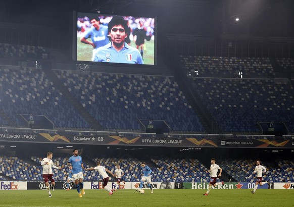 A photo in memory of Argentine soccer legend Diego Armando Maradona who died yesterday, is shown on the screen at the Napoli against Rijeka group F soccer match of the Europa League, at the San Paolo  ...