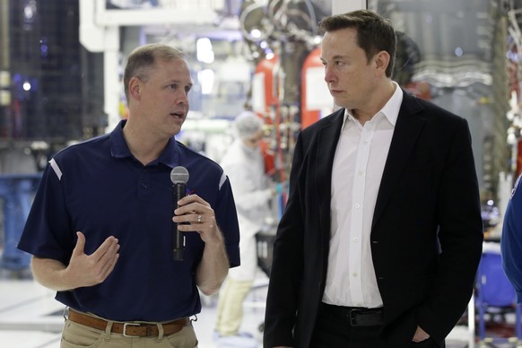 NASA Administrator Jim Bridenstine, left, talks with SpaceX chief engineer Elon Musk about the progress to fly astronauts to and from the International Space Station, from American soil, as part of th ...