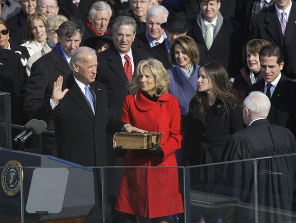 Vice President-elect Joe Biden, with his wife Jill at his side, takes the oath of office from Justice John Paul Stevens, as his wife holds the Bible at the U.S. Capitol in Washington, Tuesday, Jan. 20 ...