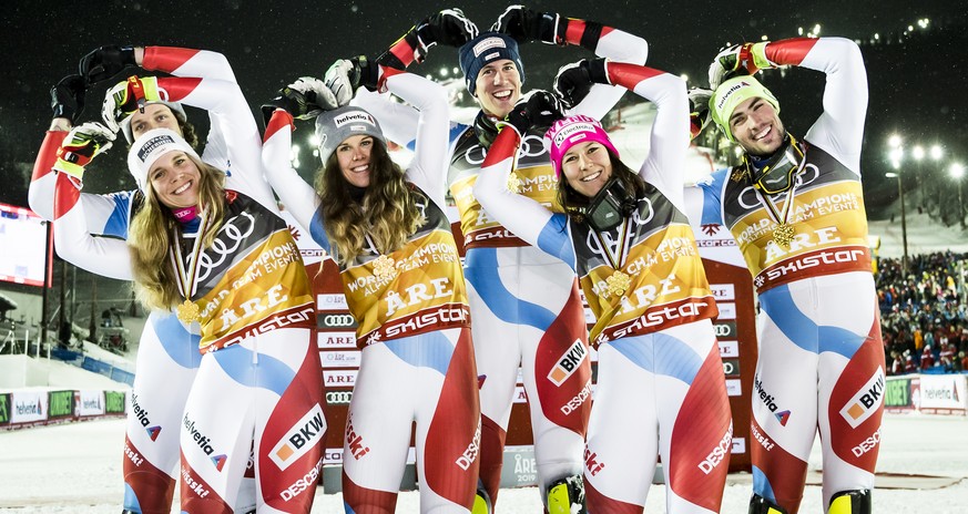 Gold medals, Andrea Ellenberger, Sandro Simonet, Aline Danioth, Ramon Zenhaeusern, Wendy Holdener and Daniel Yule of Switzerland, from left to right, celebrate during the medals ceremony after the Alp ...