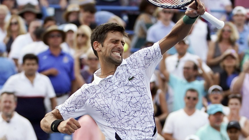 Novak Djokovic, of Serbia, reacts after defeating Roger Federer, of Switzerland, during the finals at the Western &amp; Southern Open tennis tournament, Sunday, Aug. 19, 2018, in Mason, Ohio. (AP Phot ...