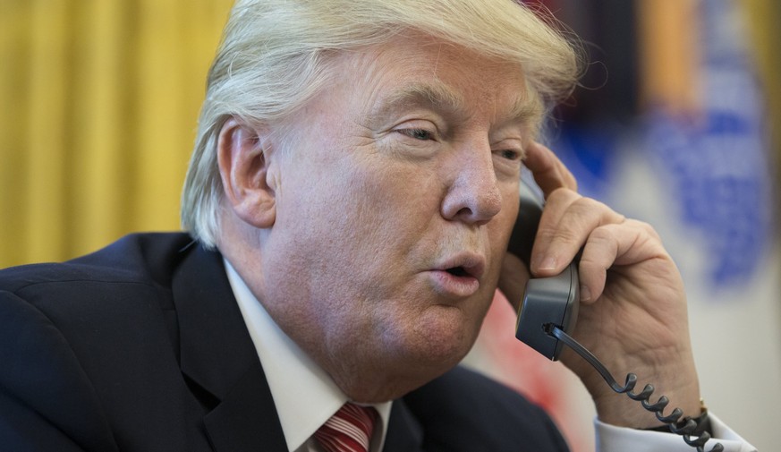 epa06052897 US President Donald J. Trump makes a phone call to Prime Minister of Ireland to Leo Varadkar in the Oval Office of the White House in Washington, DC, USA, 27 June 2017. EPA/MICHAEL REYNOLD ...