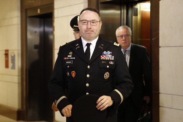 Army Lieutenant Colonel Alexander Vindman, a military officer at the National Security Council, center, arrives on Capitol Hill in Washington, Tuesday, Oct. 29, 2019, to appear before a House Committe ...