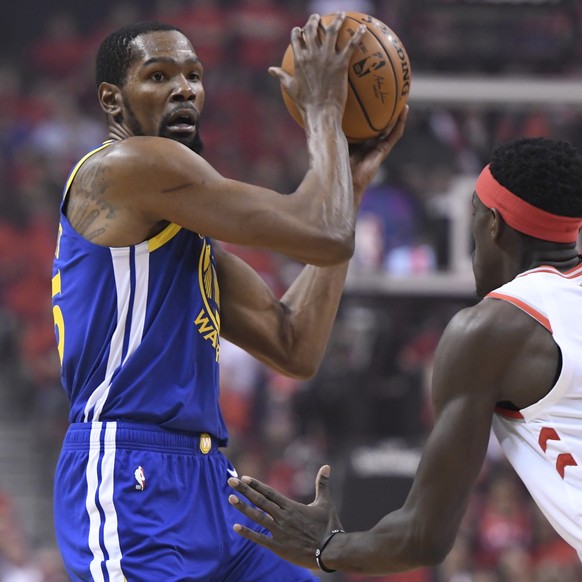 Golden State Warriors forward Kevin Durant, left, protects the ball from Toronto Raptors forward Pascal Siakam (43) during first-half basketball game action in Game 5 of the NBA Finals in Toronto, Mon ...