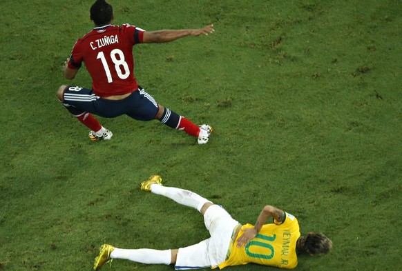 Brazil&#039;s Neymar holds his back after being challenged by Colombia&#039;s Camilo Zuniga during their 2014 World Cup quarter-final match at the Castelao arena in Fortaleza July 4, 2014. Brazil&#039 ...