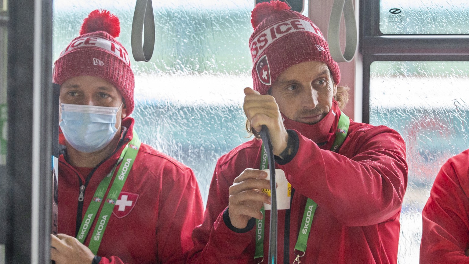 Patrick Fischer, 2nd left, head coach of Switzerland national ice hockey team, right, and Marco Bayer, left, assistant coach of Switzerland national ice hockey team, leave the Olympic Sports Center on ...