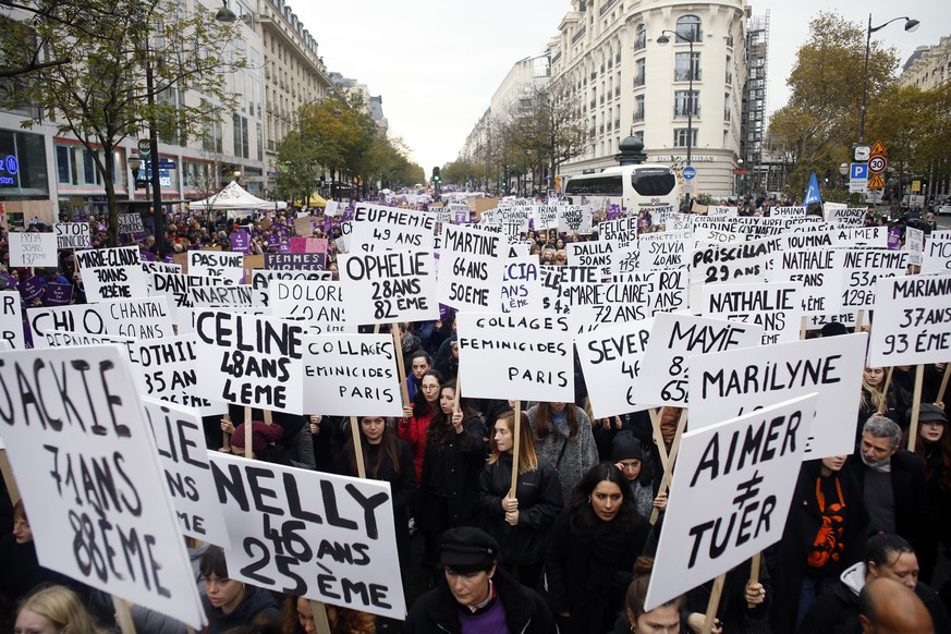 Women hold placards with the names of the women killed by their husband since the beginning of the year, as they march against domestic violence, in Paris, Saturday, Nov, 23, 2019. Activists hold a ma ...