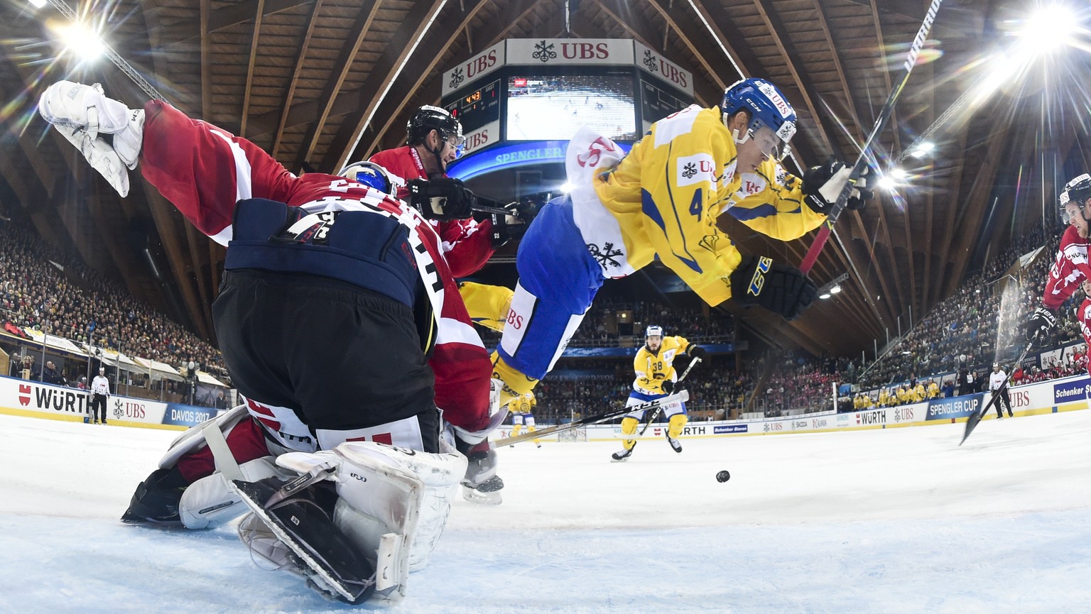 Davos&#039; Tomi Sallinen,right, fights for the puck with Team Canada&#039;s goalkeeper Kevin Poulin, during the game between Team Canada and HC Davos at the 91th Spengler Cup ice hockey tournament in ...