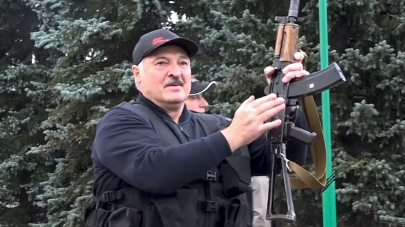 This image made from video provided by the State TV and Radio Company of Belarus, shows Belarus President Alexander Lukashenko armed with a Kalashnikov-type rifle near the Palace of Independence in Mi ...