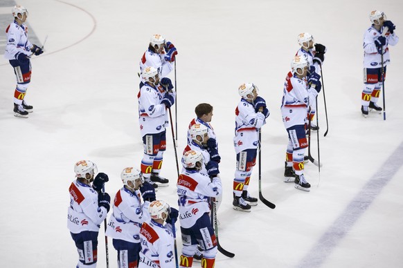 Lions&#039; players look on disappointed after losing against Geneve-Servette, during a National League regular season game of the Swiss Championship between Geneve-Servette HC and ZSC Lions, at the i ...