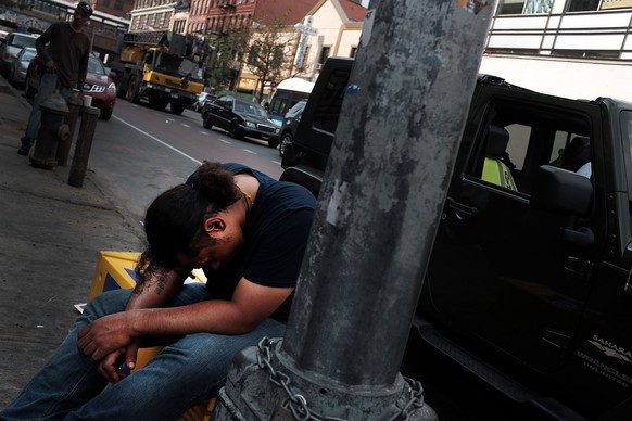 NEW YORK, NY - AUGUST 31: A passed out man sits along a sidewalk in an area which has witnessed an explosion in the use of K2 or &#039;Spice&#039;, a synthetic marijuana drug in East Harlem on August  ...