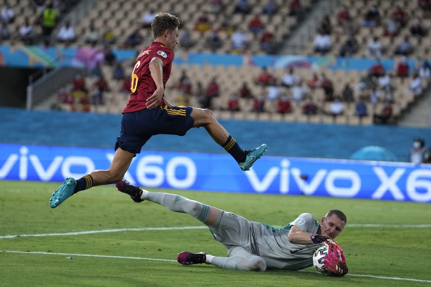Sweden&#039;s goalkeeper Robin Olsen saves on an attempt to score by Spain&#039;s Marcos Llorente during the Euro 2020 soccer championship group E match between Spain and Sweden at La Cartuja stadium  ...