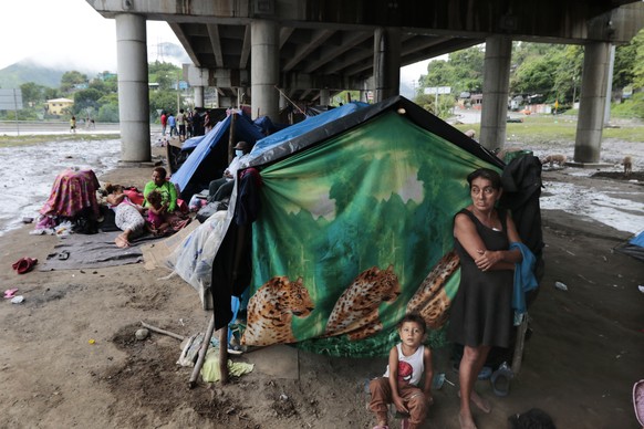 Hurricane victims take refuge under a bridge in San Pedro Sula, Honduras, Saturday, Nov. 21, 2020. Shelters for people whose homes were flooded or damaged by hurricanes Eta and Iota in Honduras are no ...