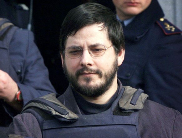 FILE - In this Monday, March 20, 2000 file photo, Marc Dutroux, right, is led out the courthouse of Neufchateau, Belgium, 180 kilometers (130 miles) east of Brussels. Marc Dutroux, a pedophile and chi ...