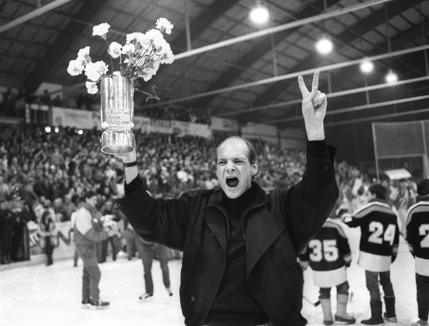 ARCHIVBILD ZUM KEYSTONE-SDA-TEXT ZUM JUBILAEUMSJAHR 1990 --- Der ueberglueckliche HC Lugano-Trainer John Slettvoll haelt nach dem 5 zu 7 Sieg gegen den HC Davos den Eishockey-Meisterbecher in die Hoeh ...
