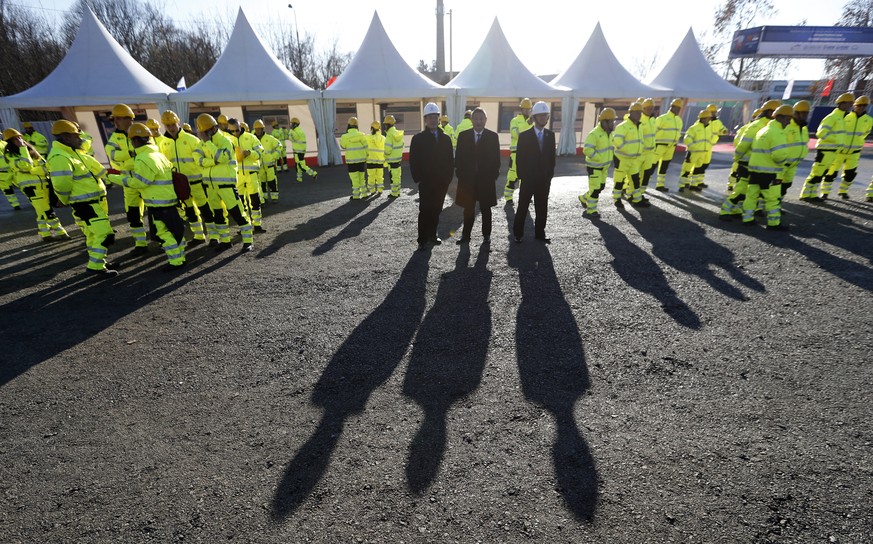 FILE - In this Nov. 28, 2017, file photo, workers and officials await the ceremony of the reconstruction of a railway line between Budapest and Belgrade, a project financed mainly by China, as a &quot ...