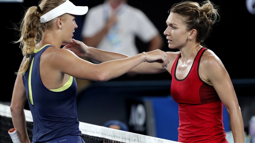 Denmark&#039;s Caroline Wozniacki, left, is congratulated by Romania&#039;s Simona Halep after winning the women&#039;s singles final at the Australian Open tennis championships in Melbourne, Australi ...