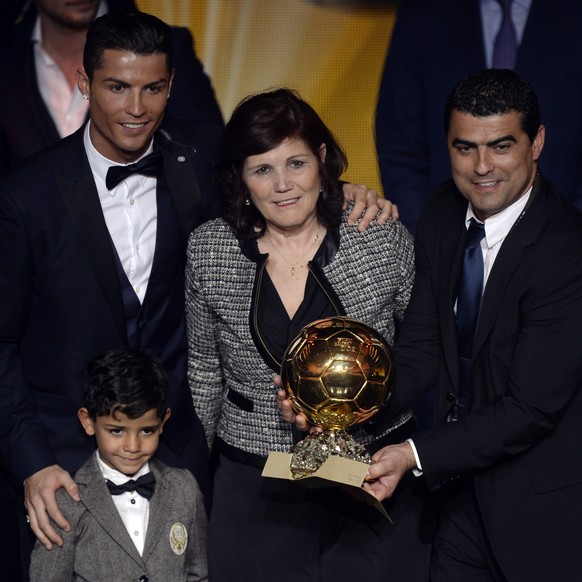 Cristiano Ronaldo, top left, of Portugal, his son Cristiano Jr., his mother Maria Dolores dos Santos Aveiro and his brother Hugo pose with the trophy after winning the FIFA Men&#039;s soccer player of ...