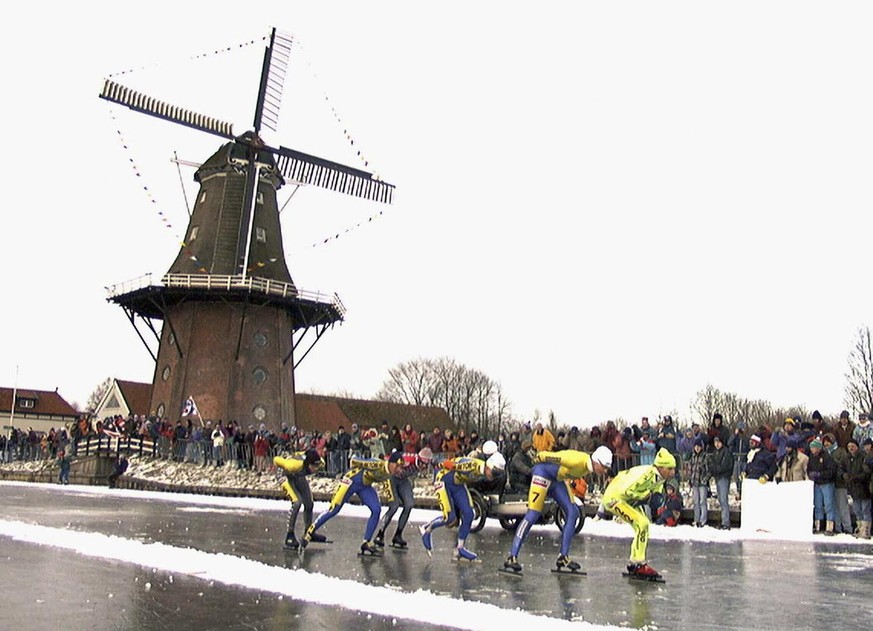 FILE - In this Jan. 4, 1997, file photo, skaters pass a windmill as some 16,000 people participate in the historic 200km skating spectacle the &#039;Elfstedentocht&#039; (eleven-cities-course) in Bird ...