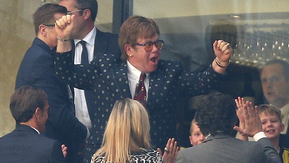 Former Watford owner Elton John celebrates in the stands after the English Premier League soccer match between Watford and Tottenham Hotspur at Vicarage Road, Watford, England, Sunday, Sept. 2, 2018.  ...