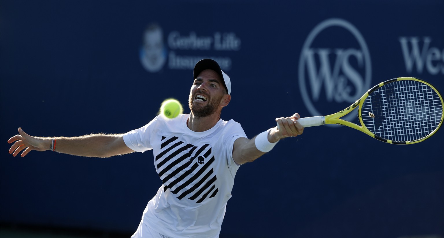 epa08621252 Adrian Mannarino of France hits a return to John Millman of Australia during their first round match at the Western and Southern Open at the USTA National Tennis Center in Flushing Meadows ...