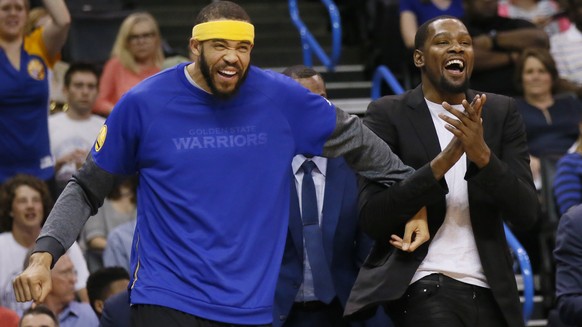 Golden State Warriors center JaVale McGee, left, and forward Kevin Durant, right, celebrate on the bench following a basket by the Warriors during the first quarter of an NBA basketball game against t ...