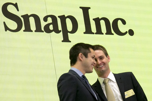 Snapchat co-founders Bobby Murphy, left, and CEO Evan Spiegel ring the opening bell at the New York Stock Exchange as the company celebrates its IPO, Thursday, March 2, 2017. (AP Photo/Richard Drew)