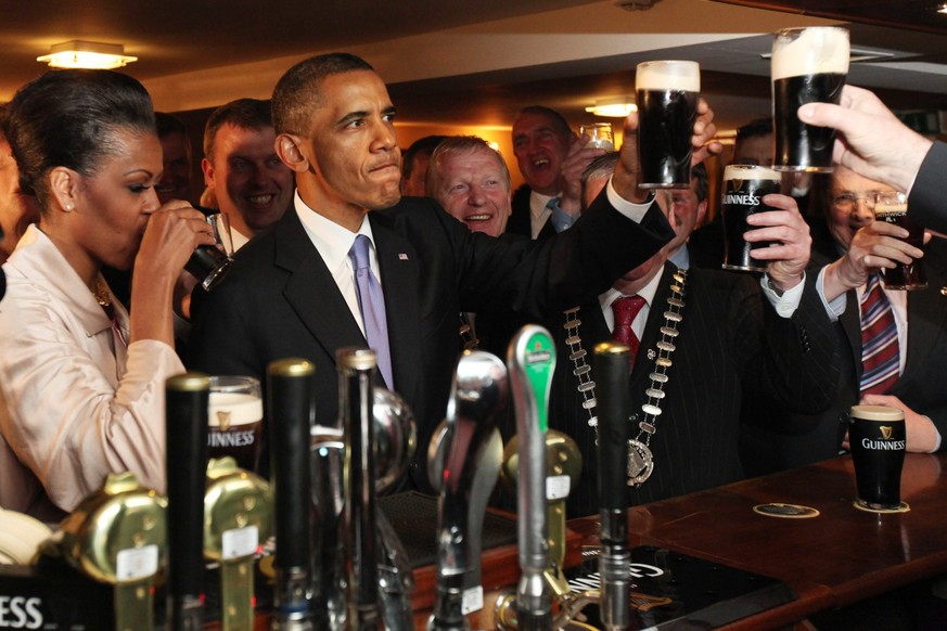 epa05706721 (FILE) - A file picture dated 23 May 2011 shows US President Barack Obama (2-L) and his wife Michelle (L) as they enjoy a pint of Guinness beer in Hayes Bar in the town of Moneygall, the h ...