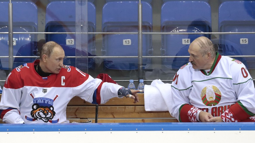 FILE In this file photo taken on Friday, Feb. 15, 2019, Russian President Vladimir Putin, left, and Belarusian President Alexander Lukashenko speak during an ice hockey game at Shayba Arena in the Bla ...