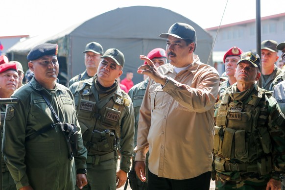 epa07326221 A handout photo made available by the Miraflores Press, shows Venezuelan President Nicolas Maduro (C) as he leads a military exercise, in Caracas, Venezuela, 27 January 2019. Maduro led on ...