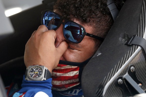 Driver Bubba Wallace, right, is overcome with emotion as he sits in his car prior to the start of the NASCAR Cup Series auto race at the Talladega Superspeedway in Talladega Ala., Monday June 22, 2020 ...
