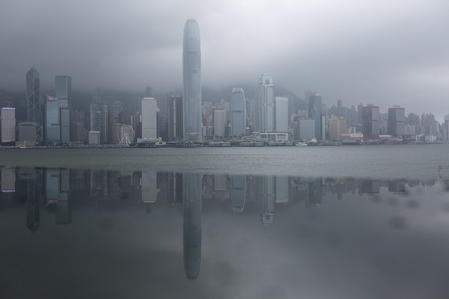 epa05451539 The Hong Kong island skyline is reflected in a metallic panel during typhoon Nida in Hong Kong, China, 02 August 2016. Nida is the first major typhoon to shut down Hong Kong this year. Cla ...