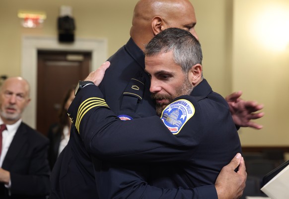 epaselect epa09371562 Officer Michael Fanone of the DC Metropolitan Police (R) and Private First Class Harry Dunn of the US Capitol Police embrace after testifying before members of the Select Committ ...