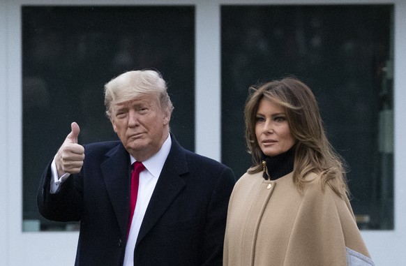 President Donald Trump, accompanied by first lady Melania Trump, gives thumbs up as he walks on the South Lawn as they depart the White House, Friday, Jan. 31, 2020, in Washington. Trump is en route t ...