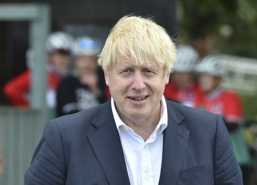 FILE - In this Tuesday, July 28, 2020 file photo, Britain&#039;s Prime Minister Boris Johnson speaks to local people at the Canal Side Heritage Centre in Beeston near Nottingham, England. Johnson is l ...
