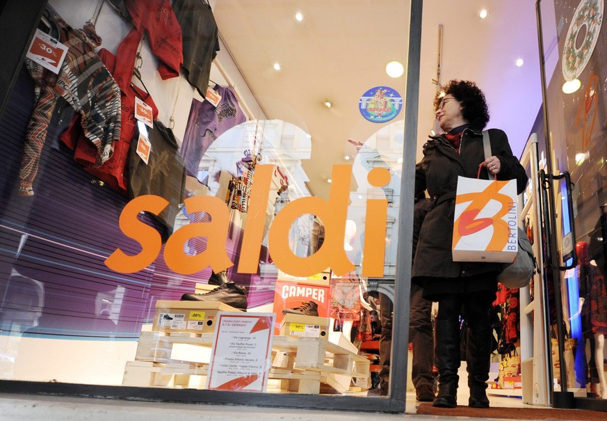 epa04343208 (FILE) A file photo dated 05 January 2012 shows people rushing by a shop window with &#039;Saldi&#039; (Sale) offers of up to 50 percent as shoppers were looking for bargains at stores dur ...