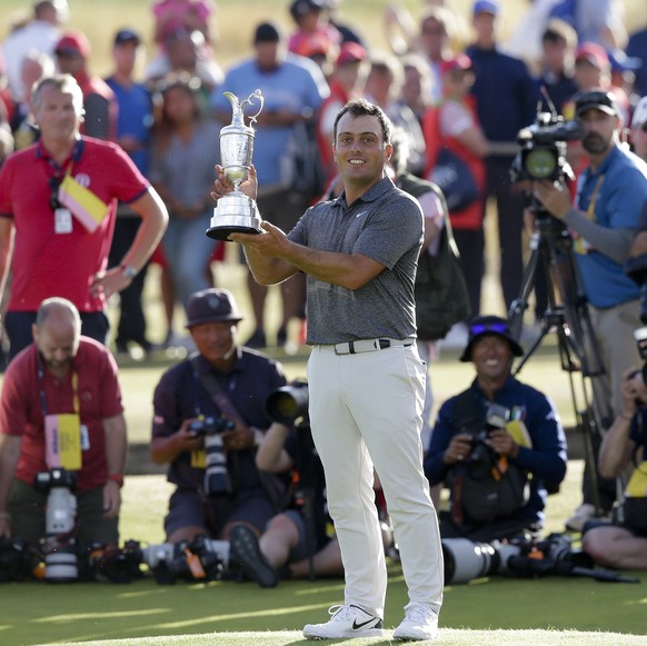 Francesco Molinari of Italy holds the trophy after winning the British Open Golf Championship in Carnoustie, Scotland, Sunday July 22, 2018. (AP Photo/Martin Cleaver)