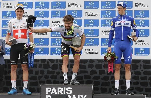 epa06655320 Bora-hansgrohe team rider Peter Sagan of Slovakia (C) celebrates on the podium after winning the 116th Paris Roubaix cycling race, France, 08 April 2018. Seen left, AG2R team rider Silvan  ...