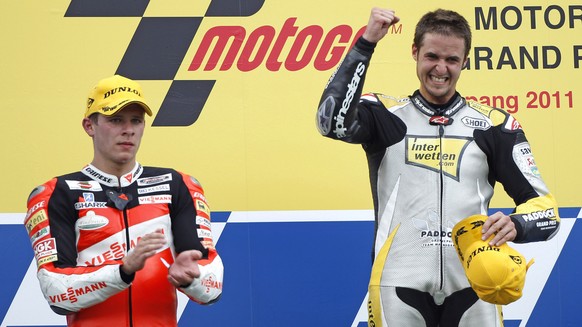 Moto2 rider Thomas Luethi of Switzerland, right, celebrates on the podium as second-placed Stefan Bradl of Germany looks on, after winning the Malaysian motorcycle Grand Prix in Sepang, Malaysia, Sund ...