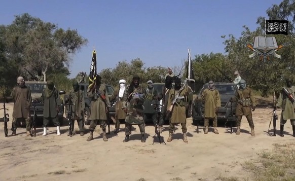 FILE - In this file image taken from video released Friday Oct. 31, 2014, by Boko Haram, Abubakar Shekau, centre, the leader of Nigeria&#039;s Islamic extremist group, surrounded by his fighters. Isla ...