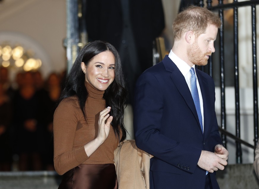 FILE - In this Tuesday, Jan. 7, 2020 file photo, Britain&#039;s Prince Harry and Meghan, Duchess of Sussex smile as they leave Canada House, in London. Prince Harry and his wife Meghan &#039;stepping  ...