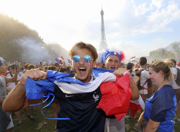 Supporters of the French soccer team celebrate after France won the World Cup final between France and Croatia, Sunday, July 15, 2018 on the Champ de Mars in Paris. France won its second World Cup tit ...