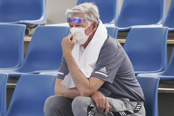A spectator wears a mask as smoke haze shrouds Melbourne during an Australian Open practice session at Melbourne Park in Australia, Tuesday, Jan. 14, 2020. Smoke haze and poor air quality caused by wi ...