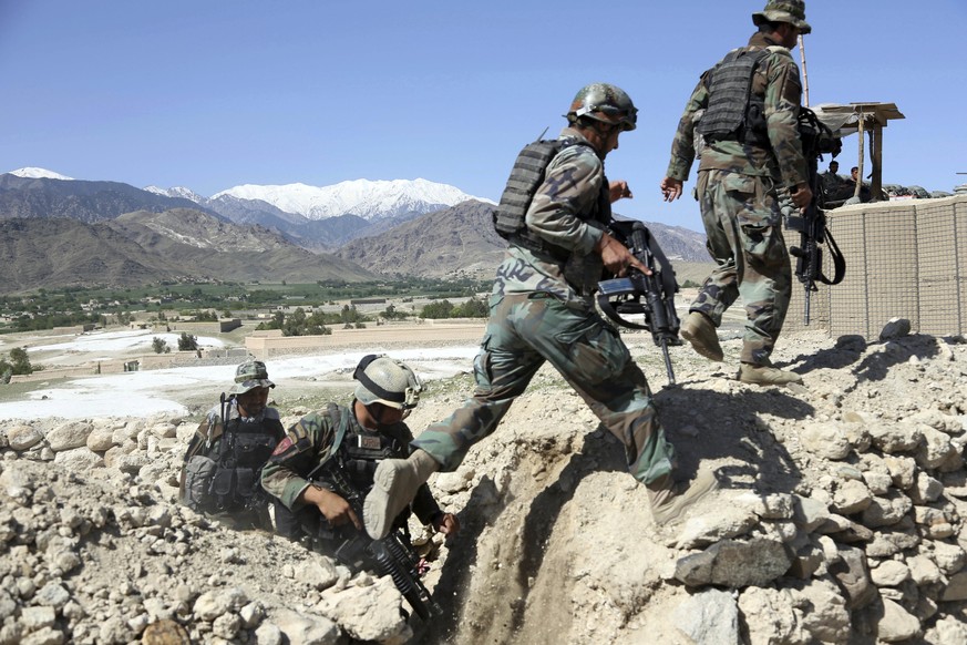 Afghan commandos patrol Pandola village near the site of a U.S. bombing in the Achin district of Jalalabad, east of Kabul, Afghanistan, Friday, April 14, 2017. U.S. forces in Afghanistan on Thursday s ...