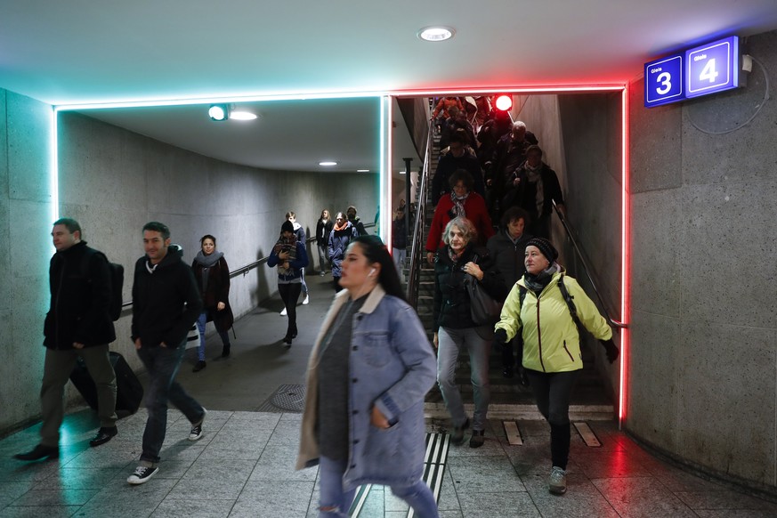 Rote und gruene Neonroehren signalisieren den Passagieren waehrend den Stosszeiten den Weg, waehrend einem Pilotversuch am Montag, 7. November 2016, im Bahnhof Bern. (KEYSTONE/Peter Klaunzer)