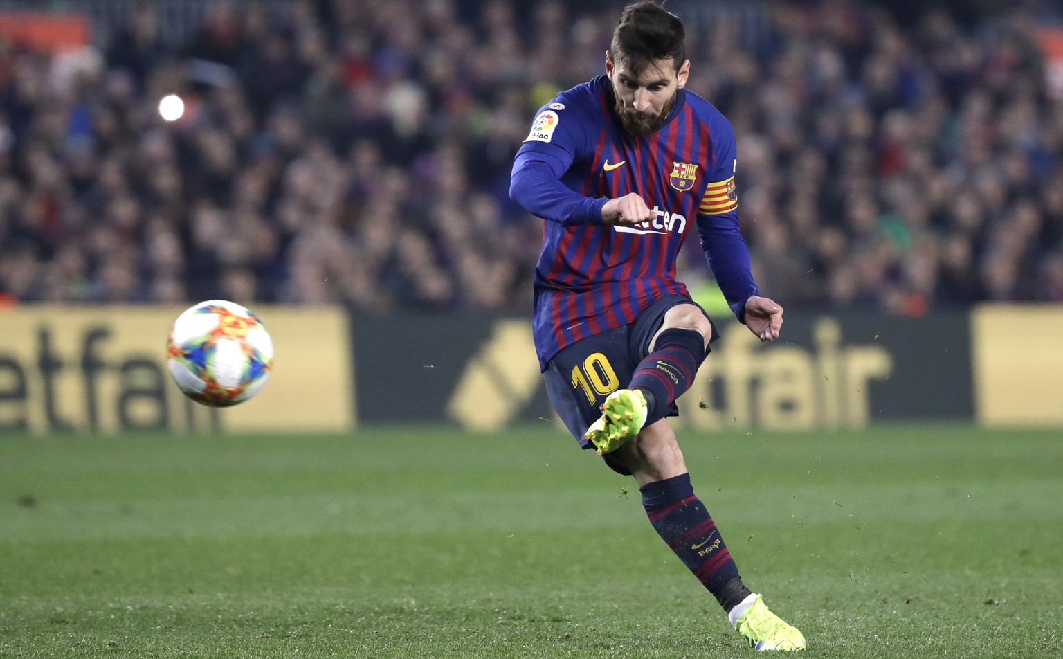Barcelona forward Lionel Messi takes a free kick during the Copa del Rey semifinal first leg soccer match between FC Barcelona and Real Madrid at the Camp Nou stadium in Barcelona, Spain, Wednesday Fe ...