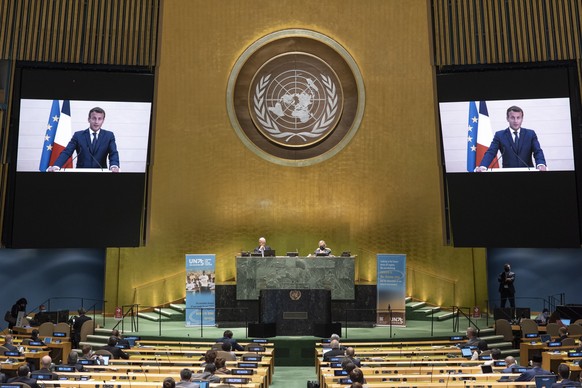 epa08687233 A handout photo made available by UN photo shows Emmanuel Macron (on screens), President of the Republic of France, speaking during the 75th General Assembly of the United Nations, in New  ...