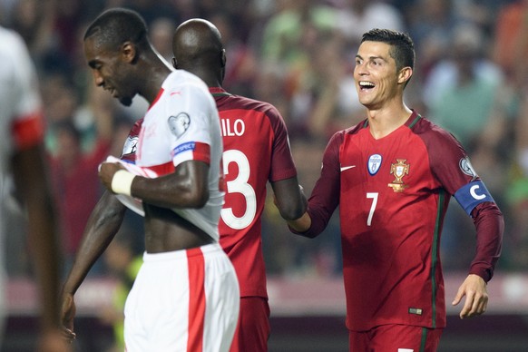 Switzerland&#039;s defender Johan Djourou, left, looks disappointed after loosing closes to the celebration of Portugal&#039;s midfielder Danilo Pereira, center, and Portugal&#039;s forward Cristiano  ...