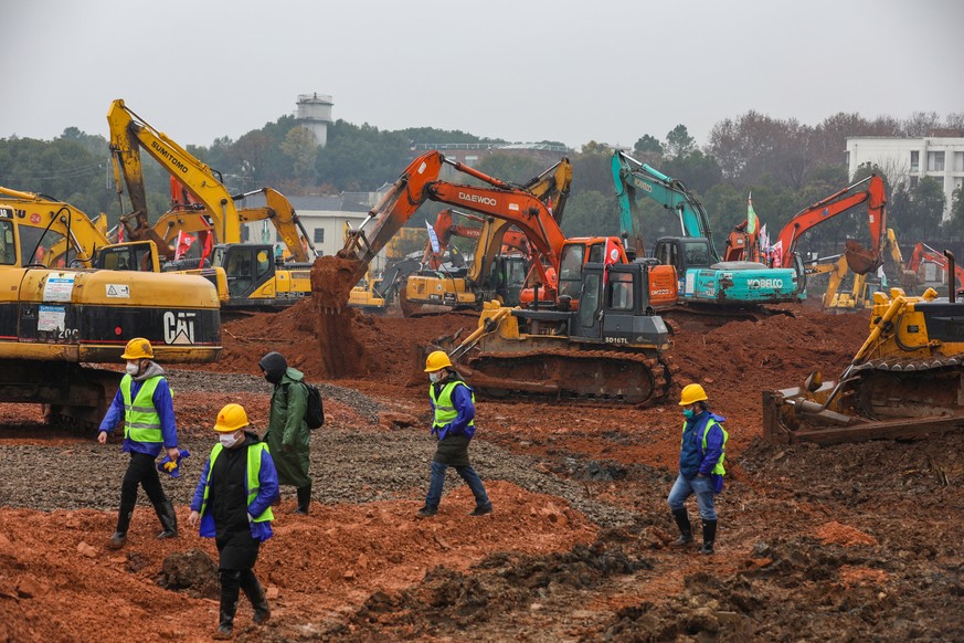 epa08157643 People work at the construction site of a field hospital in Wuhan, Hubei province, China, 24 January 2020. The 1,000-bed hospital is expected to be completed by 03 February 2020 to cope wi ...